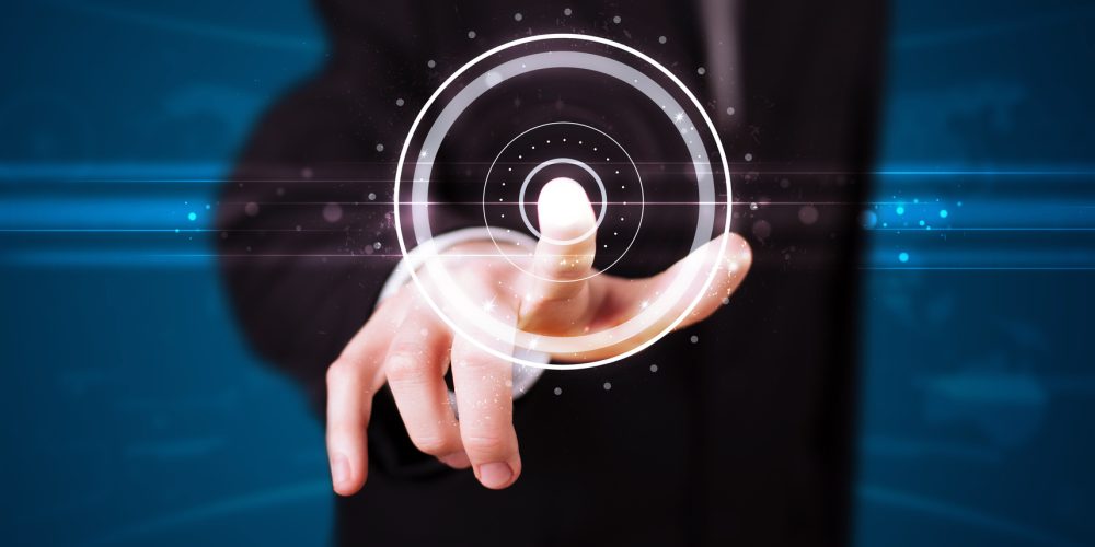 Young businessman pressing high tech type of modern buttons